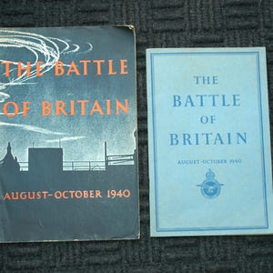 May include: Two vintage booklets titled "The Battle of Britain." The first has a dark blue cover with orange text and a silhouette of buildings. The second is light blue with blue text and a Royal Air Force emblem. Both state "August-October 1940."