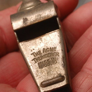 May include: A silver whistle with the words "The Acme Thunderer Made in England" engraved on the side.