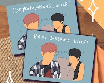 May include: Two greeting cards with a blue background and a cartoon illustration of three people. The text on the top card reads "Congratulations, beach!" and the text on the bottom card reads "Happy Birthday, beach!"