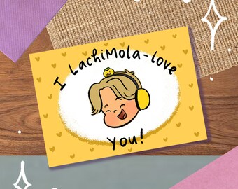 May include: A yellow card with a cartoon illustration of a person with a yellow duck on their head. The card has the text "I LachimoLa-love you!" and is decorated with small hearts.