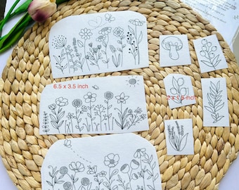 May include: Eight black and white embroidery transfer designs on white paper. The designs include various floral arrangements, a mushroom, berries, and a branch. The transfers are labeled "Botanical - 8 transfers".