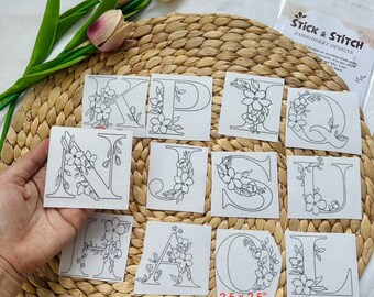 May include: A set of 10 embroidery designs featuring floral letters on white fabric. The designs are 2.5 inches by 2.5 inches. The letters are K, P, Q, N, J, S, U, H, A, and L.