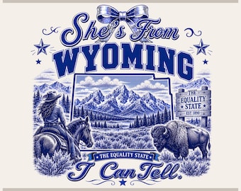 May include: A blue and white graphic design featuring the text She's From WYOMING I Can Tell. The image includes a person on horseback, a bison, a mountain range, and a sign reading The Equality State Est. 1890, all topped with a large bow.