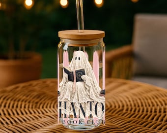 May include: A clear glass tumbler with a bamboo lid and a glass straw. The exterior features a graphic of a ghost draped in white lace reading a dark blue book, set against vertical pink brushstrokes with the text HANTO BOOK CLUB below.