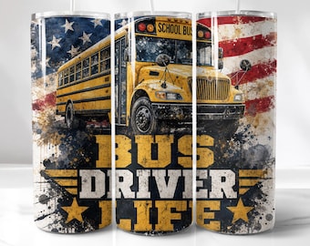 May include: A cylindrical tumbler featuring a yellow school bus graphic against a backdrop of the American flag. The design includes a watercolor-style paint splatter effect and the bold text BUS DRIVER LIFE in yellow and white lettering.