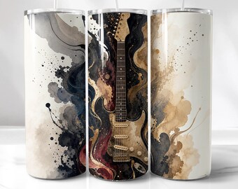 May include: A cylindrical stainless steel tumbler featuring a wrap-around design of an electric guitar centered against a background of abstract watercolor splashes in shades of black, dark gray, cream, and muted gold with dark paint splatters.