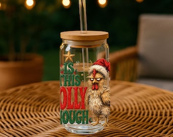May include: A clear glass tumbler with a bamboo lid and a glass straw. The glass features a graphic of a grumpy chicken wearing a red Santa hat, a gold star, and the green and red text that reads: IS THIS JOLLY ENOUGH.