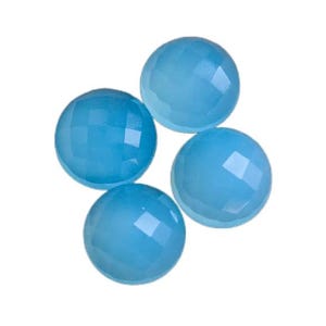 May include: Four round, light blue gemstone cabochons with a faceted finish.