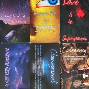 May include: Nine colorful cards with inspirational messages and images. The cards feature phrases like "Don't be afraid of your own power", "Transmute that shit", "Love is your superpower", "Claircognizant", and "Cartomancy".