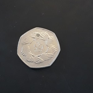 A 1973 Accession to Europe 50 pence coin.