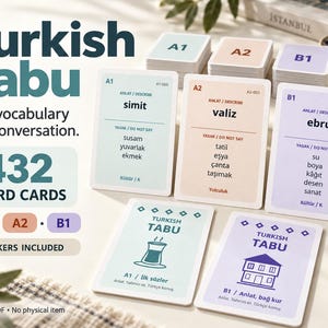 May include: A Turkish Tabu card game set featuring 432 word cards across A1, A2, and B1 levels. The cards are light blue, peach, and light purple, displaying Turkish vocabulary words, forbidden terms, and illustrations of a tea glass and a house.