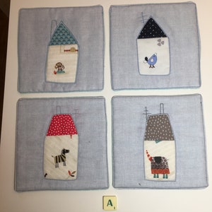 May include: Four blue fabric squares with a white border, each featuring a different animal in a house-shaped applique. The animals are a monkey, a bird, a zebra, and an elephant.