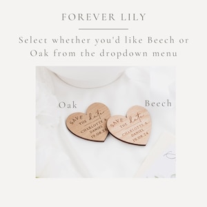 May include: Two heart-shaped wooden save-the-date announcements. The text "SAVE THE DATE" is engraved, along with the names "CHARLOTTE & DANIEL" and the date "19.08.24". The text "FOREVER LILY" is at the top.