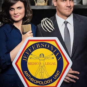 May include: Promotional image for the television show "Bones" featuring two actors. The show's logo is in the foreground, with the text "Jeffersonian Medico Legal Anthropology Unit" and "Squintern". A human skull is visible on a shelf.