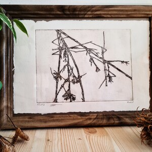 May include: A framed black and white print of a stylized drawing of branches. The print is on a textured paper with a white background. The print is signed and dated "2019" in the bottom right corner.