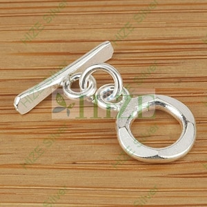 May include: Silver toggle clasp with a round ring. The clasp is designed for jewelry making and has a polished finish.