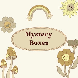 May include: Cream-colored graphic with the text "Mystery Boxes" in a brown oval. The image features cartoon illustrations of a rainbow, flowers, and mushrooms, all with smiling faces. The overall design has a retro, whimsical aesthetic.