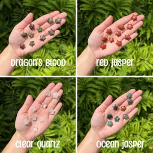 May include: Four hands holding different types of star-shaped polished stones. The stones are labeled "Dragon's Blood", "Red Jasper", "Clear Quartz", and "Ocean Jasper".
