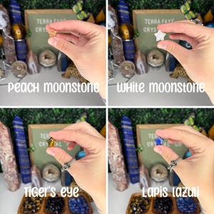 May include: Four star-shaped crystal stones in different colors: peach moonstone, white moonstone, tiger's eye, and lapis lazuli. The stones are held in the hands of a person.