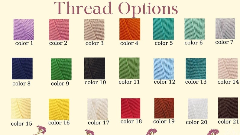 Op de afbeelding: Een kaart met 21 verschillende kleuren garen. De kleuren zijn gerangschikt in drie rijen van zeven. De kleuren zijn: lavendel, roze, beige, oranje, teal, lichtgroen, grijs, donkerblauw, groen, zwart, olijfgroen, lichtblauw, donkerblauw, lichtroze, cr&egrave;me, geel, wit, rood, bruin, wit en bruin.