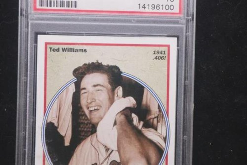 May include: A baseball card featuring Ted Williams, with the text "Ted Williams" and "1941 .406!". The card is encased in a clear protective holder. The card has a red border and a sepia-toned image of Williams.