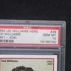 May include: A graded trading card encased in a clear plastic holder. The card features text that reads "1992 UD WILLIAMS HERO TED WILLIAMS 1941-.406!" and "#29 GEM MT 10". The card is a collectible item.