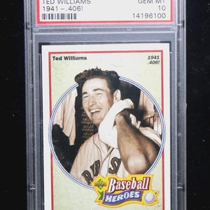May include: A 1992 Upper Deck Ted Williams baseball card, graded by PSA. The card features a black and white image of Ted Williams in a baseball uniform. The card is encased in a clear plastic holder with red and white text.