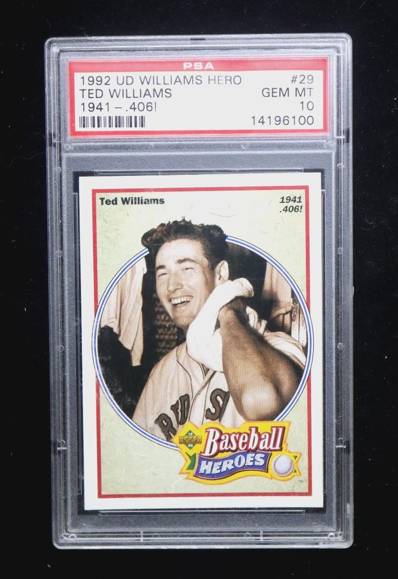 May include: A 1992 Upper Deck Ted Williams baseball card, graded by PSA. The card features a black and white image of Ted Williams in a baseball uniform. The card is encased in a clear plastic holder with red and white text.