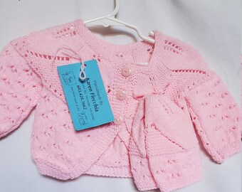 Knit Baby Long sleeve bolero sweater with hat fits 6-9 months in a light pink color.