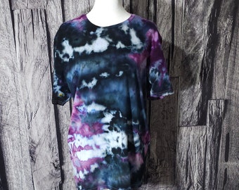 May include: A tie-dye t-shirt with a black, white, and purple color scheme. The shirt has a cloud-like pattern.