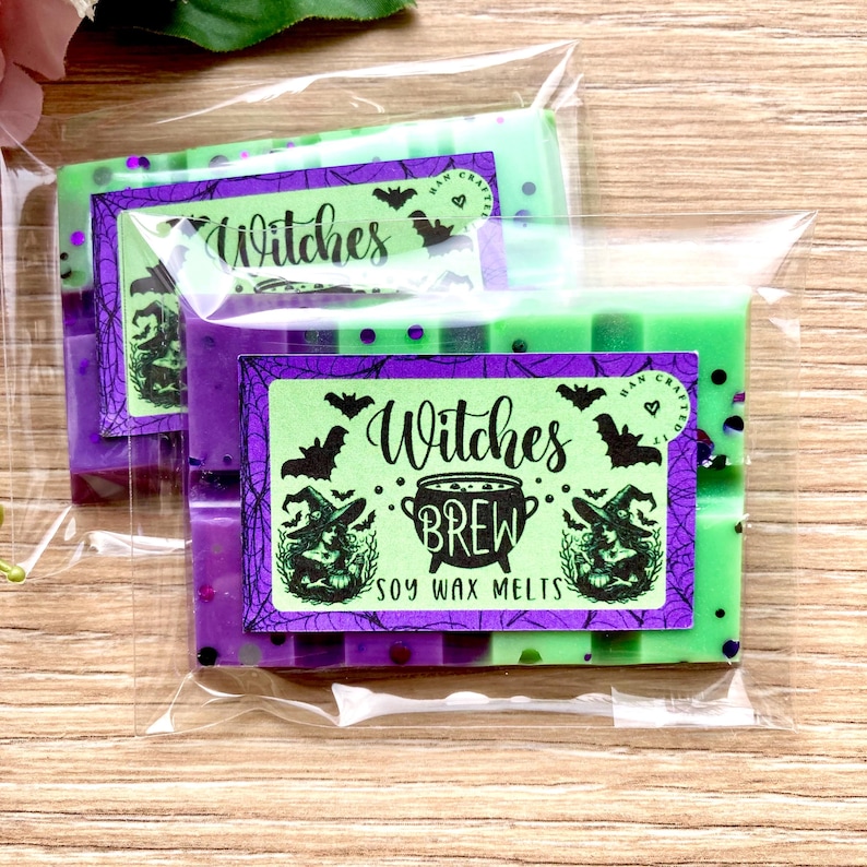 May include: Two green and purple soy wax melts with a witch theme. The label says "Witches Brew Soy Wax Melts" with a witch and cauldron graphic. The melts are packaged in a clear plastic bag.