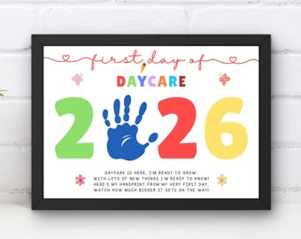 May include: A framed sign with the text first day of DAYCARE 2026, featuring a blue handprint replacing the zero. The design includes colorful numbers, small butterfly and flower illustrations, and a poem about growing and handprints.