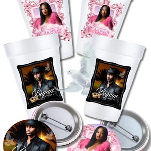 May include: White foam cups and pinback buttons featuring memorial portraits. The cups display images of a woman in a pink frame and a man in a black frame, with names and memorial text. The buttons have similar designs.