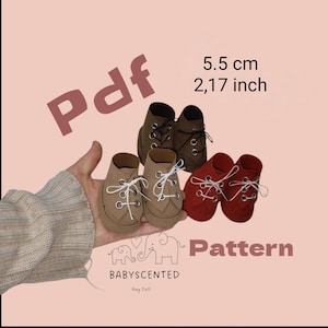 May include: A collection of miniature shoes in brown, red, and dark brown, each with laces. The image includes the text "Pdf" and "Pattern", along with the measurement "2.17 inch" and the brand name "BABYSCENTED".