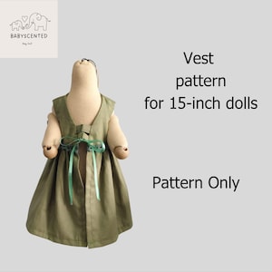 May include: An olive green vest for a doll, designed for 38 cm dolls, with a bow closure and green ribbons. The image includes the text "Vest pattern for 15-inch dolls" and "Pattern Only".