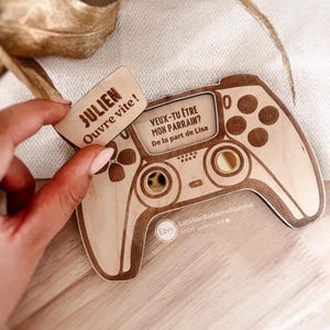 Surprise proposal box in the shape of a game controller, for asking someone to be a godfather, godmother, or uncle, etc.