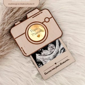 Surprise pregnancy announcement box in the shape of a camera with ultrasound scan