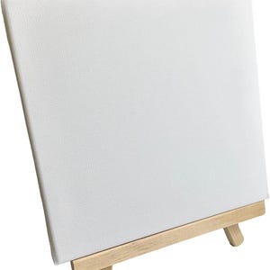May include: A white canvas mounted on a small wooden easel. The canvas is blank and ready for painting.