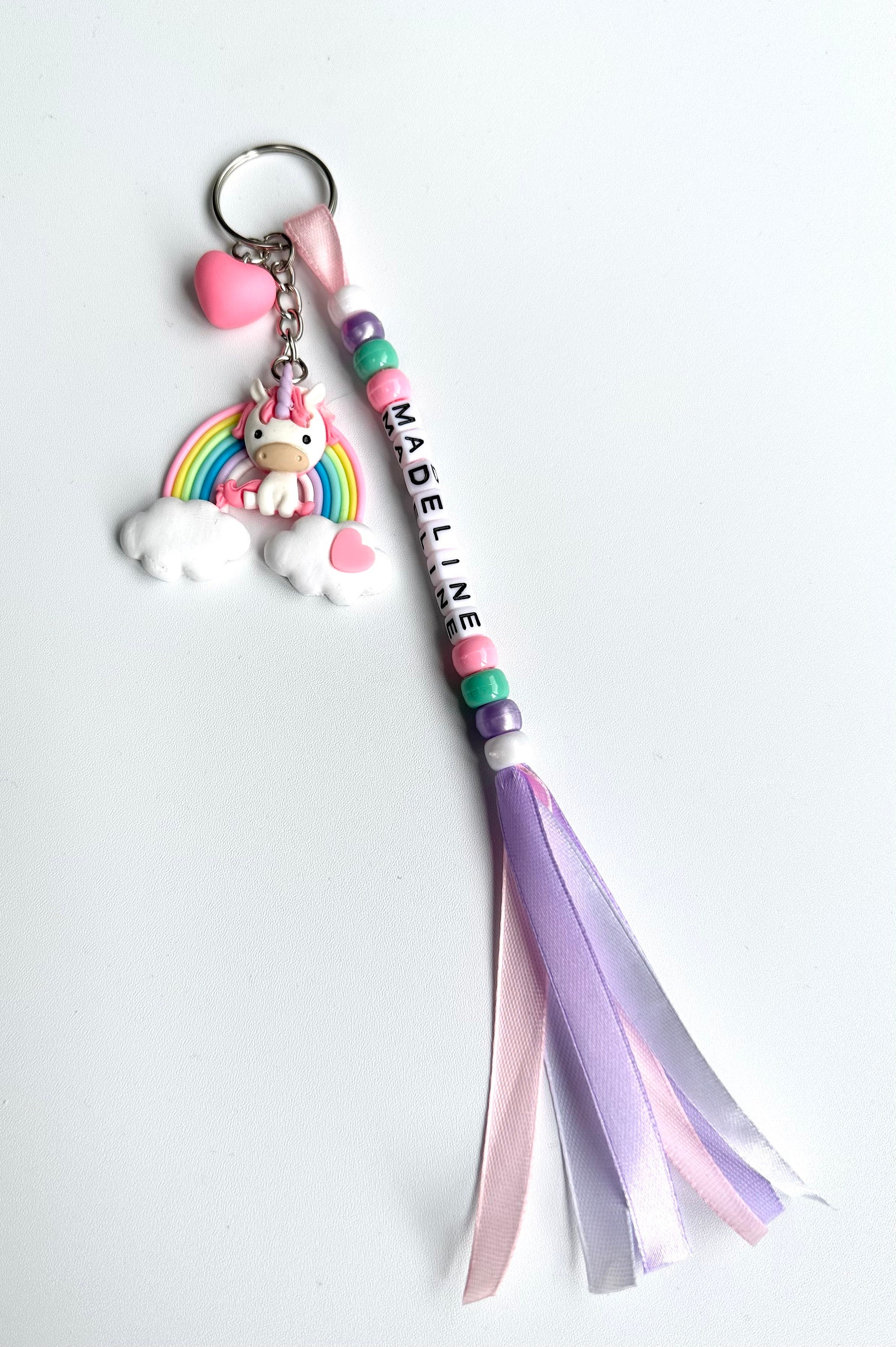 Colourful Handmade Personalised Keyring with a Cute Large Pony Sitting on a Rainbow with Heart Charm