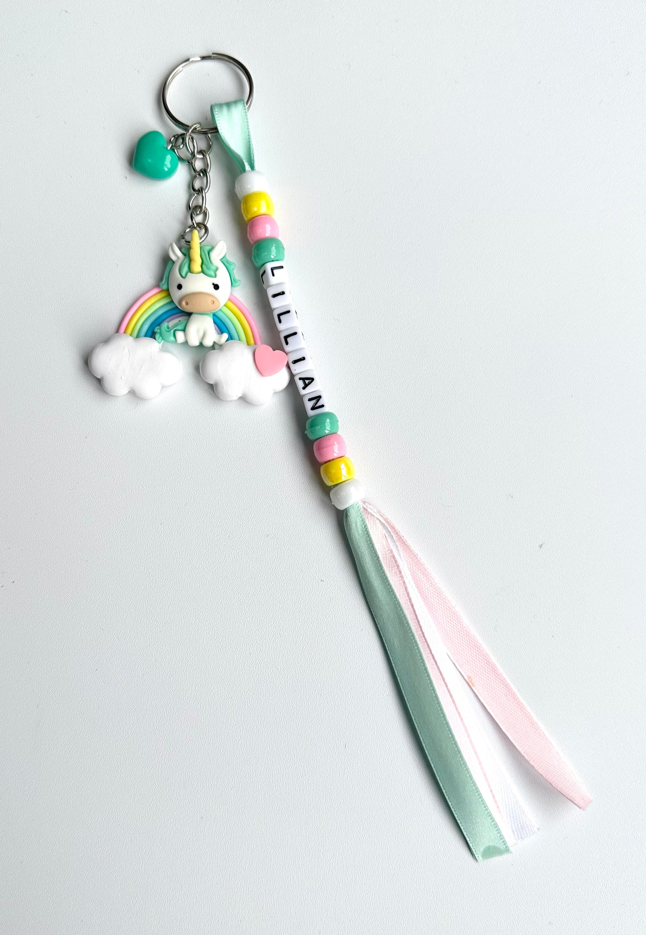Colourful Handmade Personalised Keyring with a Cute Large Pony Sitting on a Rainbow with Heart Charm