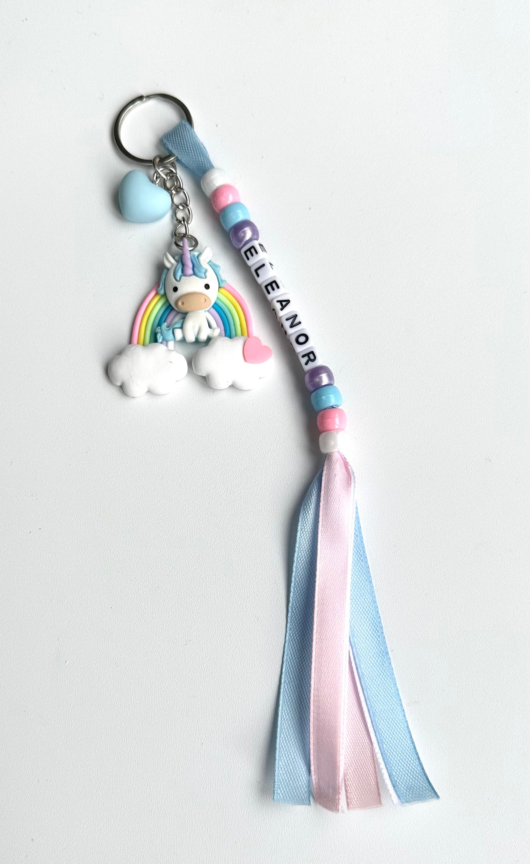 Colourful Handmade Personalised Keyring with a Cute Large Pony Sitting on a Rainbow with Heart Charm