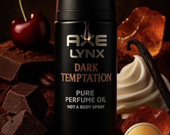 May include: A black Axe Lynx Dark Temptation perfume oil bottle with gold lettering and a Limited Edition sticker. The image includes a cherry, chocolate chunks, coffee beans, vanilla, and a swirl of cream.
