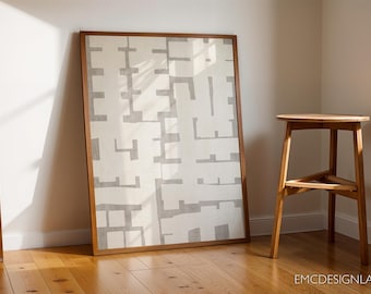 May include: A framed abstract art print with a white background and a gray geometric pattern. The print is hanging on a white wall next to a wooden stool.