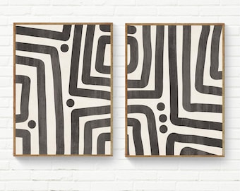 May include: Two rectangular wall art prints featuring a cream background with bold, dark charcoal grey hand-painted style geometric lines and circular dots. Each print is encased in a thin, light-toned wooden frame, displaying abstract patterns.