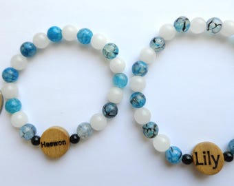 Nmixx beaded bracelet with a laser engraved member bead