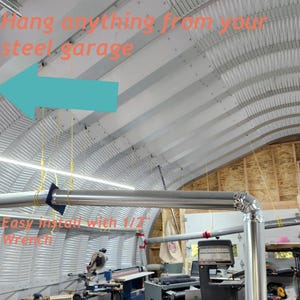 May include: A metal garage ceiling with a blue arrow pointing to a metal bracket. The text "Hang anything from your steel garage" is visible in the image. The text "Easy install with 1/2" wrench" is also visible in the image.