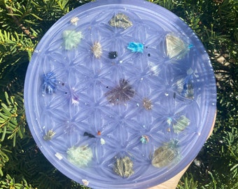 May include: A purple resin tray with a flower of life design and embedded crystals and stones.