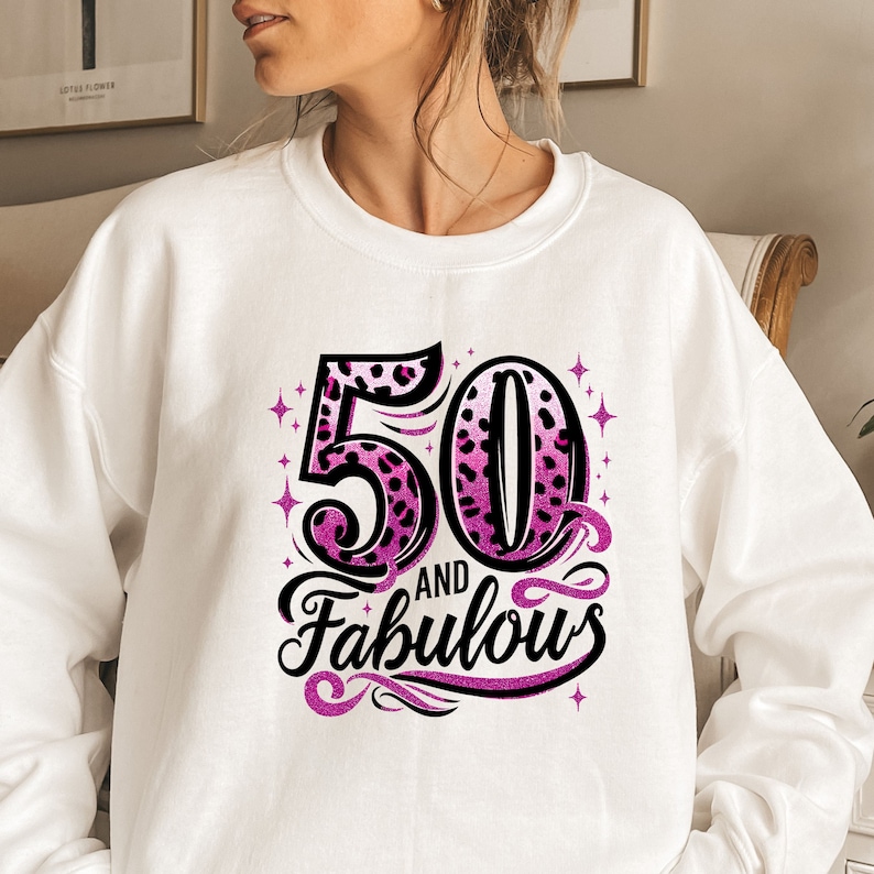 May include: White sweatshirt with a pink and black leopard print design that says "50 and Fabulous".