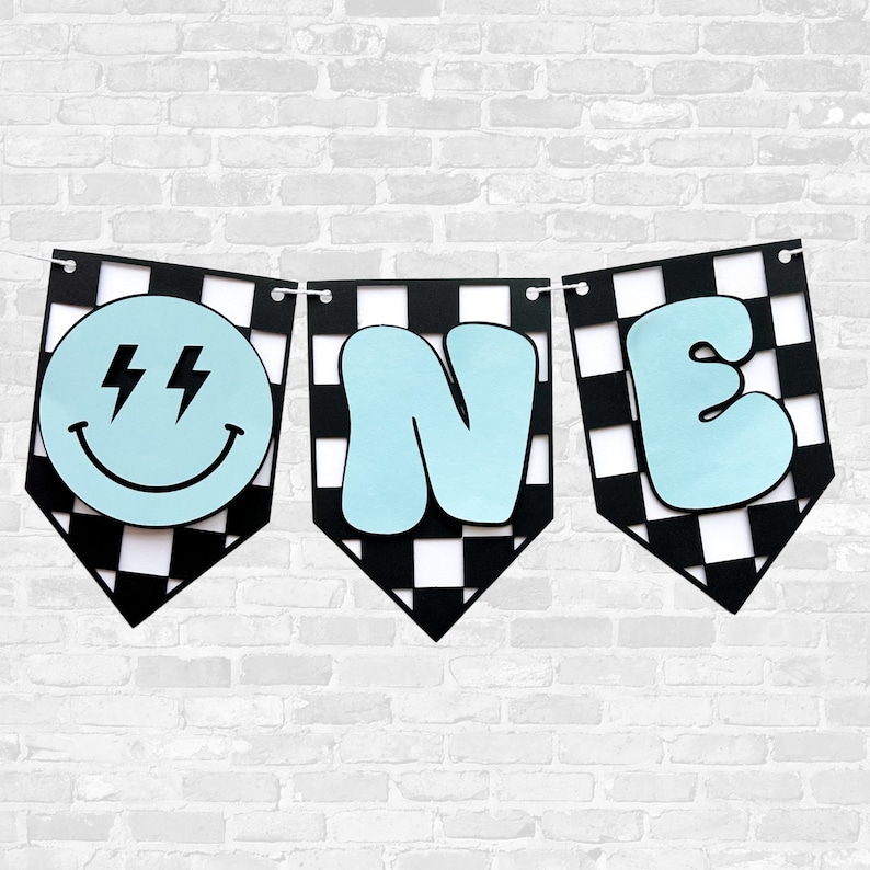 May include: Black and white checkered banner with the word "ONE" in light blue. The "O" is a smiley face with lightning bolts for eyes.