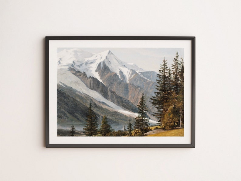 May include: A framed painting depicting a snow-capped mountain range with a forest in the foreground. The mountains are a light grey with a white snow cap. The forest is a dark green with a few brown trees. The painting is framed in a dark grey frame.